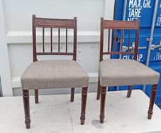 Two vintage mahogany dining chair with a pediment-style top rail, turned spindle back and turned front legs seat in a textured gray fabric