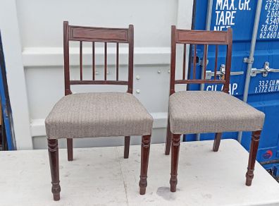 Two vintage mahogany dining chair with a pediment-style top rail, turned spindle back and turned front legs seat in a textured gray fabric