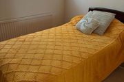 Single bed with dark wood headboard