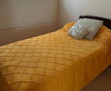 Single bed with dark wood headboard