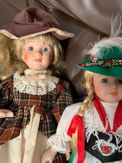5 porcelain dolls with extra clothing perfect condition