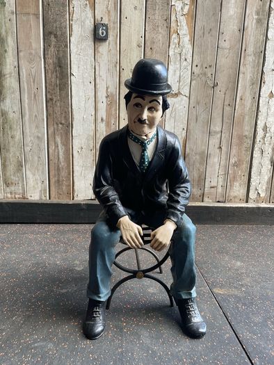 Charlie Chaplin resin sculpture figurine in metal chair