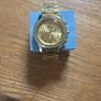 Gold coloured watch with diamonds around the face Image 3