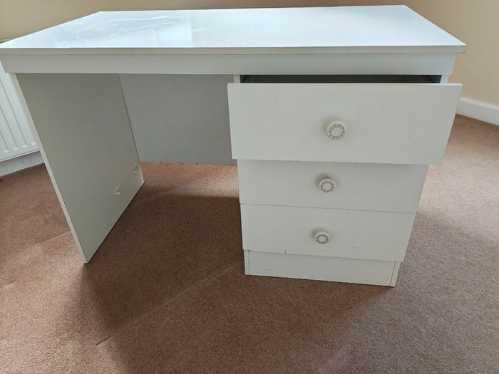 White desk with three good sized drawers.