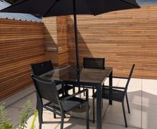 Black Table and Chairs 4 seater glass top table & black parasol