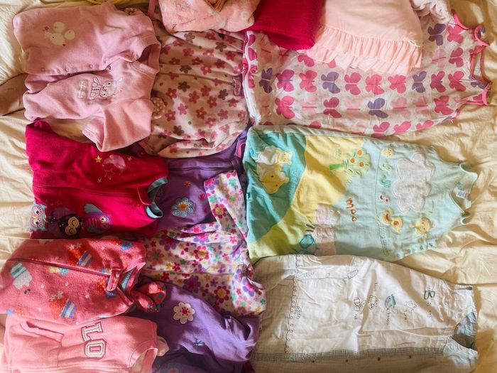 10 all in ones, 3 baby sleep bag, 4 pink blankets
