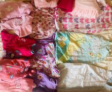 10 all in ones, 3 baby sleep bag, 4 pink blankets