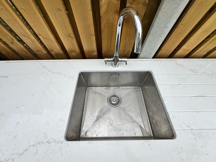 Narrow Sink Along With Vanity Unit And Pipes; Kitchen Sink And Quartz Worktop Unit With Wooden Inparts