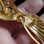 Vintage gold tone bow brooch. Image 2