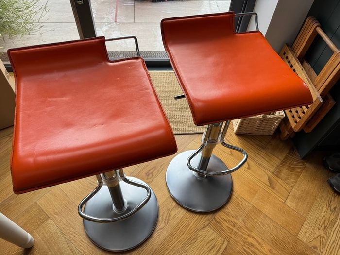 Vintage Italian orange leather bar stools.