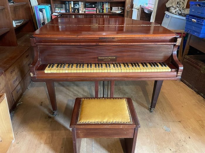 a circa-1931 Monington & Weston baby grand with matching stool.