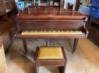 a circa-1931 Monington & Weston baby grand with matching stool.