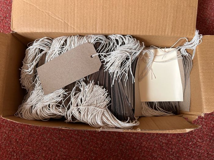 Box of strung tags/labels