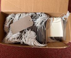 Box of strung tags/labels
