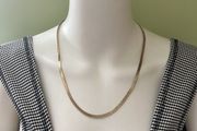 Gold tone snake chain necklace