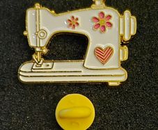 Sewing machine, pin back badge.