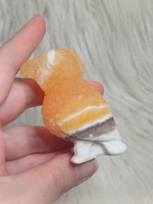 orange calcite parrot carving