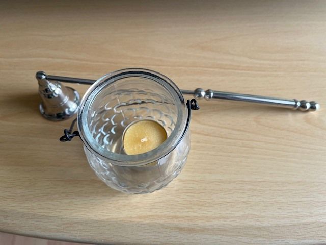 Metal Handle Candle Snuffer. Silver Finish. Moveable Head. With Hanging Tea Light. In Excellent Condition.