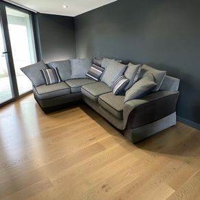 Grey corner sofa with matching scatter cushions