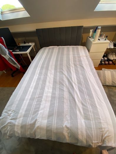 Grey double bed and mattress