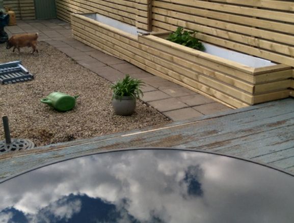 Custom timber garden fencing with integrated planters and bench