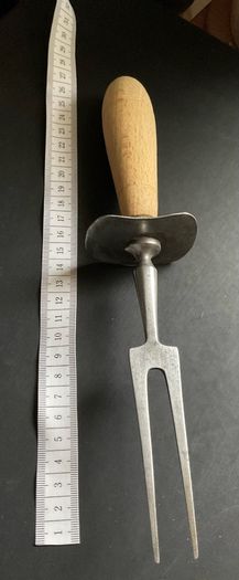 vintage meat carving fork is made of solid steel with a wooden handle and guard possible 1966 British army