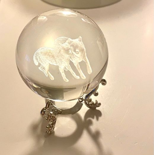 Beautiful glass ball with hologram  of  wolfs inside it
