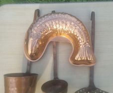 Vintage-style copper cookware and kitchen accessories.