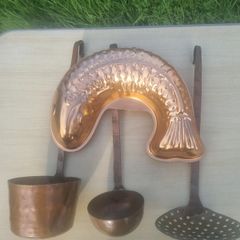 Vintage-style copper cookware and kitchen accessories.