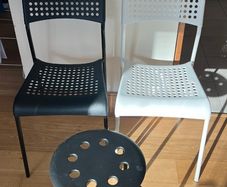 2 IKEA Adde dining chairs (1 black, 1 white) and 1 IKEA Marius stool (black).