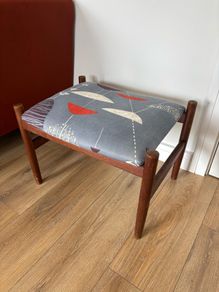 Mid Century Style Wooden Footstool / Ottoman with retro atomic-inspired upholstered seat.