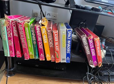 Atari 2600 Space Invaders Woody Atari 2600 with 15 individual games and 14 game Indy 500 driving