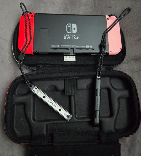 Nintendo Switch with original case and Anker adapter.