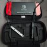 Nintendo Switch with original case and Anker adapter. Image 2