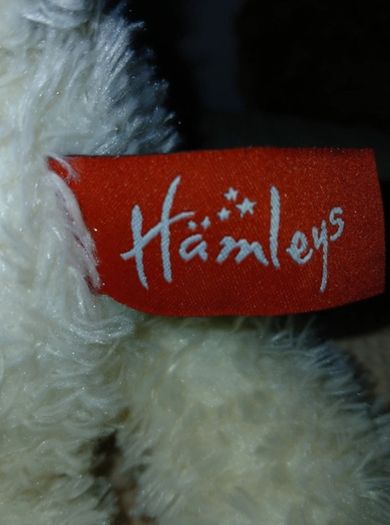 White hamleys teddy bear baby gift.  Soft white teddy with white bow.