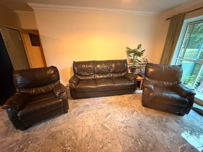 black leather sofa and arm chairs
