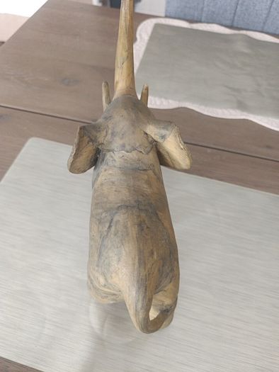 The sculpture is an antique figurine of an elephant