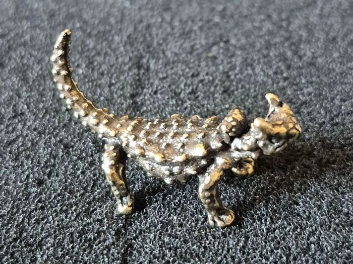 3 brass lizards.