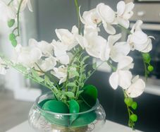 Decorative artificial Phalaenopsis orchid arrangement set in a clear glass vase