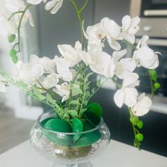 Decorative artificial Phalaenopsis orchid arrangement set in a clear glass vase