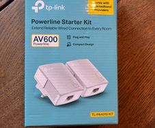 TP-Link AV600 Powerline Starter Kit, model TL-PA4010 KIT. Includes 2 powerline adapters and original box. Plug and play, ideal for extending wired internet connection to another room.
