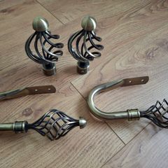 Decorative pair of antique brass cage swirl curtain hold backs with matching finials