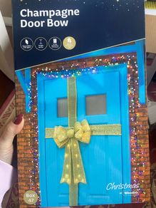 Stunning giant lit door bow
