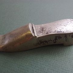 Shoe shaped match holder striker