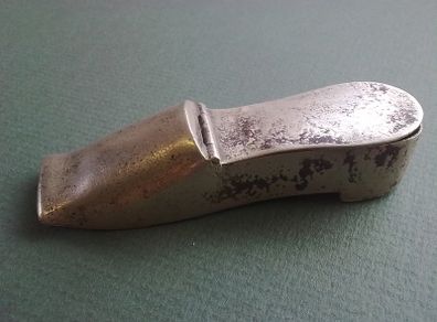 Shoe shaped match holder striker