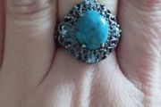 A 925 sterling silver ring with turquoise and blue topaz.