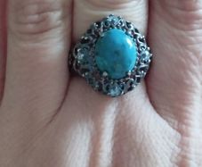 A 925 sterling silver ring with turquoise and blue topaz.