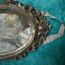 vintage-style oval picture frame in silver with a tassel and ribbon hanger Image 2