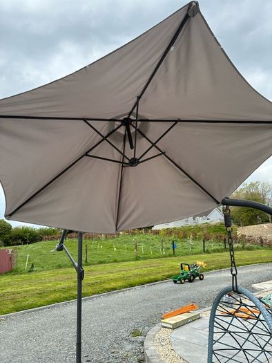 Large parasol and two weights. Bought for 170 last summer. Selling due to getting a pergola installed