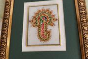 Framed in gelted frameThe painting of traditional Jewellery designs in Marble is done with gold leaf and colored glass. This art has its origin in the royal city of Jaipur  once a design is drawn on marble tile. the frame is 23 x20 cm. the center is 10 x 